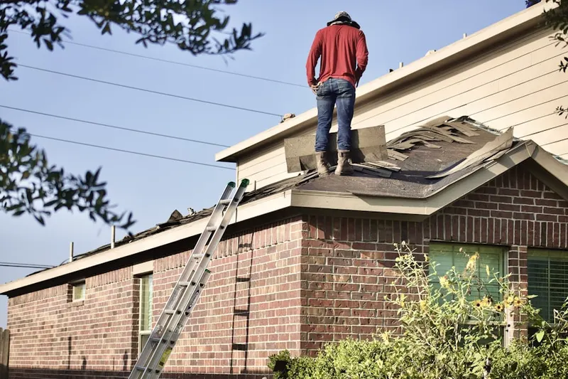 Professional roofer working on a residential roof in Aspen Grove
